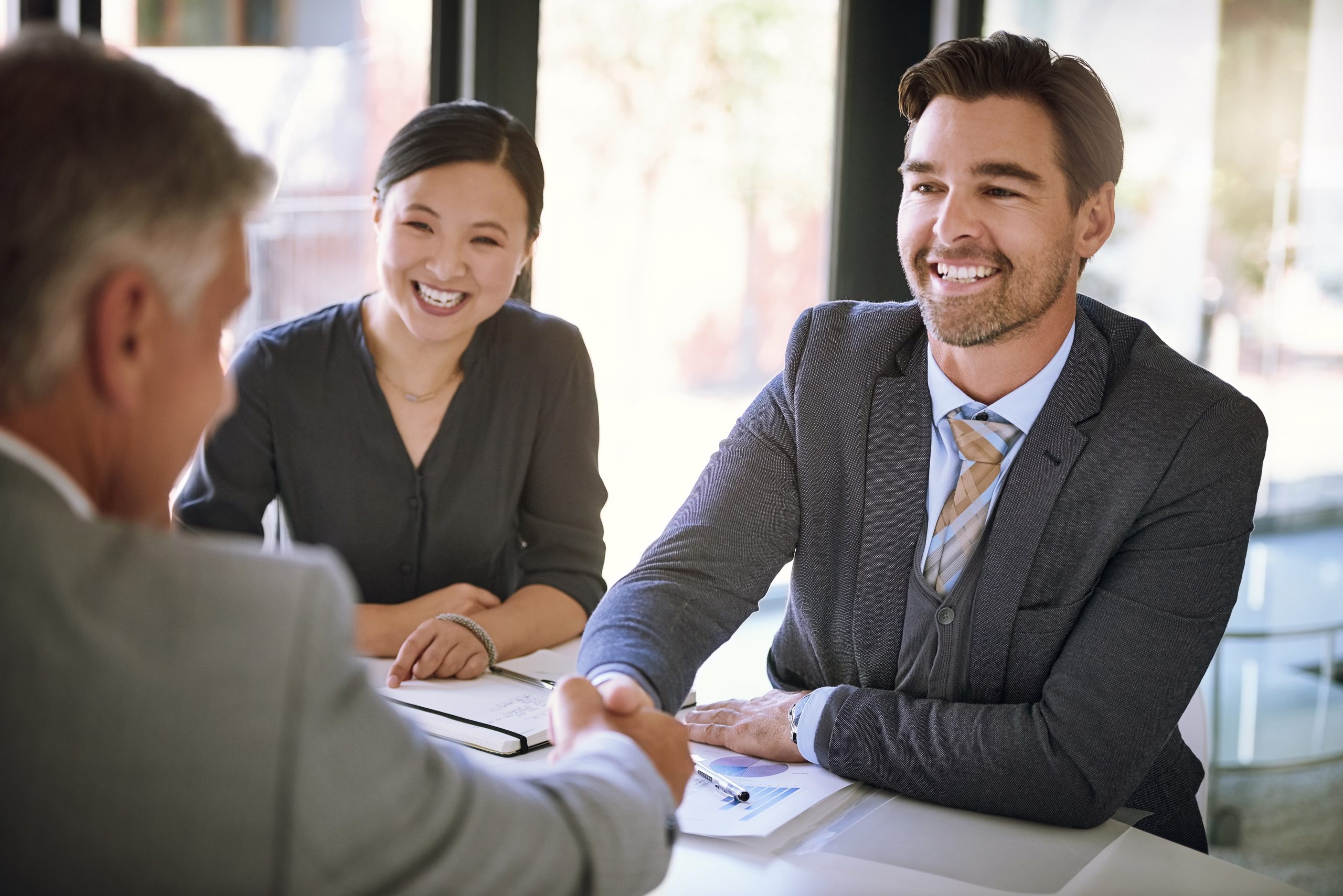 Business people, handshake and meeting success with agreement, onboarding or hiring in corporate office. Accountant, manager or employer shaking hands with new employee or clients at accounting firm